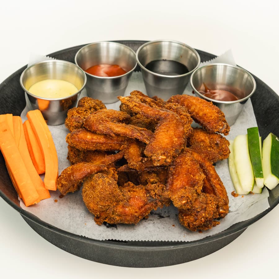 Chicken wings with carrot, celery and four dipping sauces