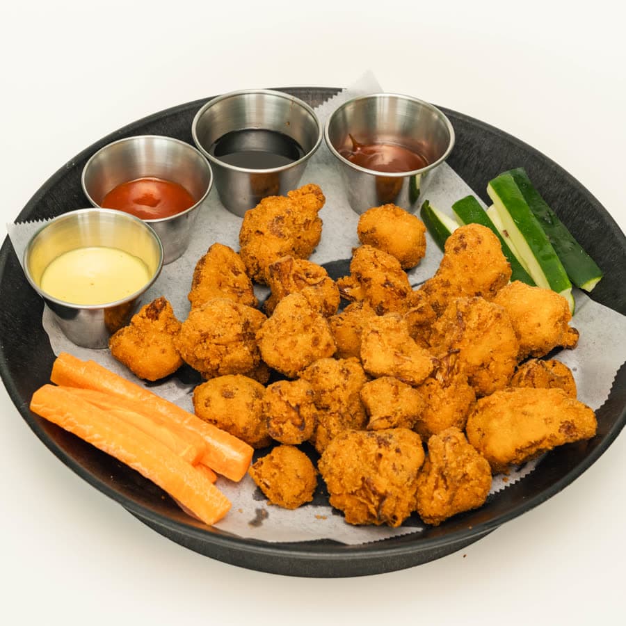 Breaded vegetarian wings with carrot, celery and dips