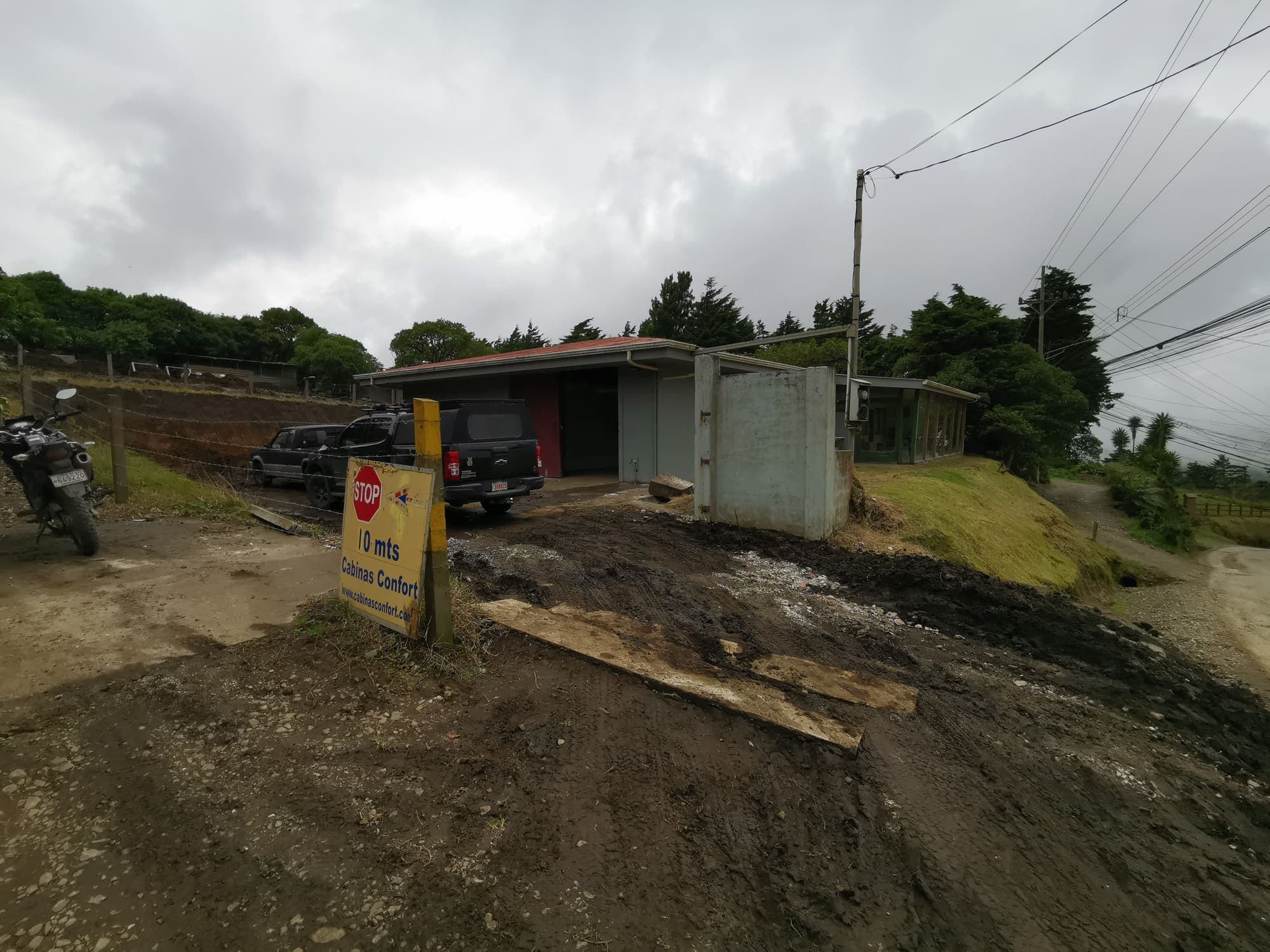 The site before work began, the shed and the rain-soaked mud
