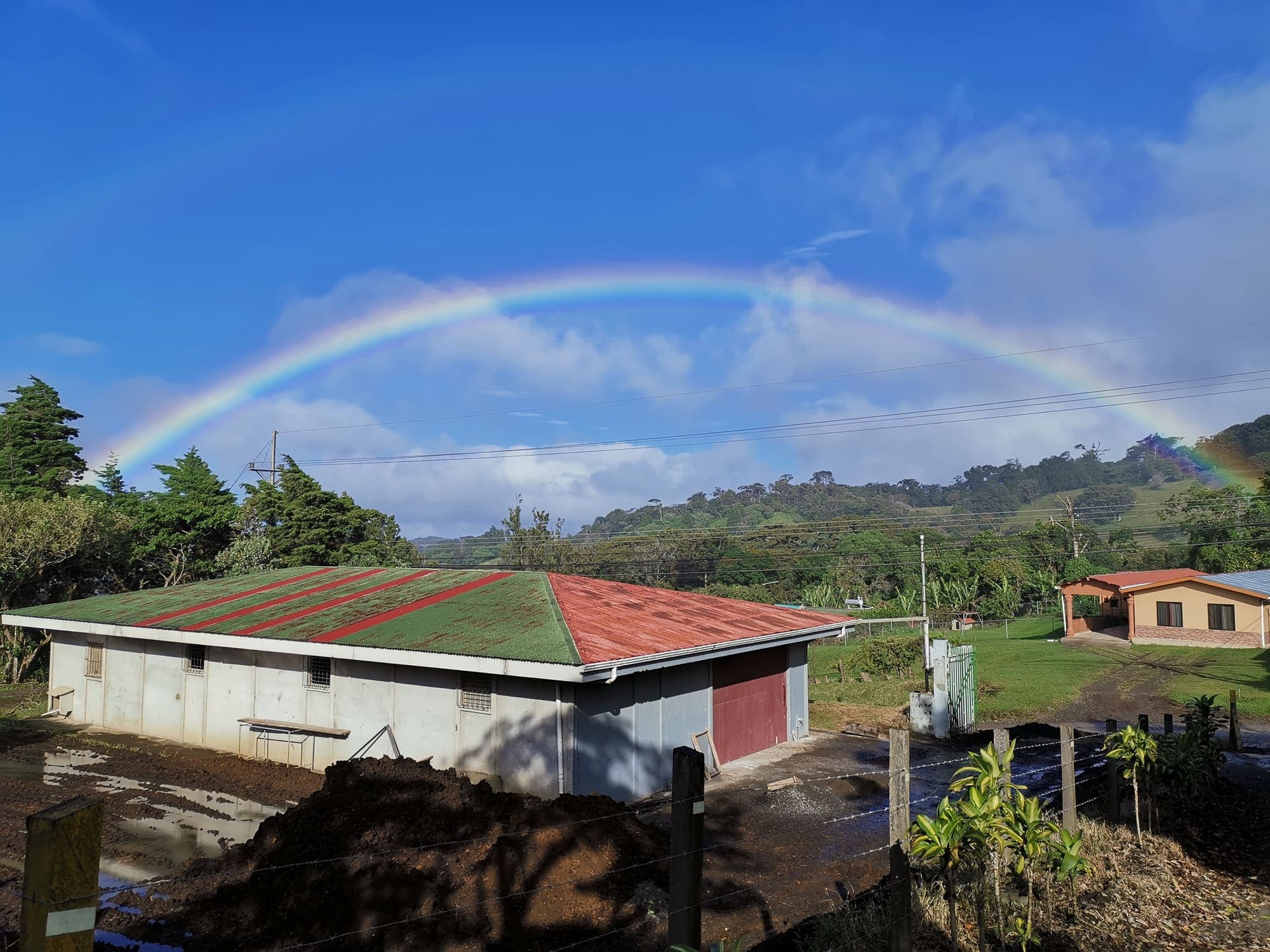 A rainbow over the green roof of the Monteverde Brewing Company brewery