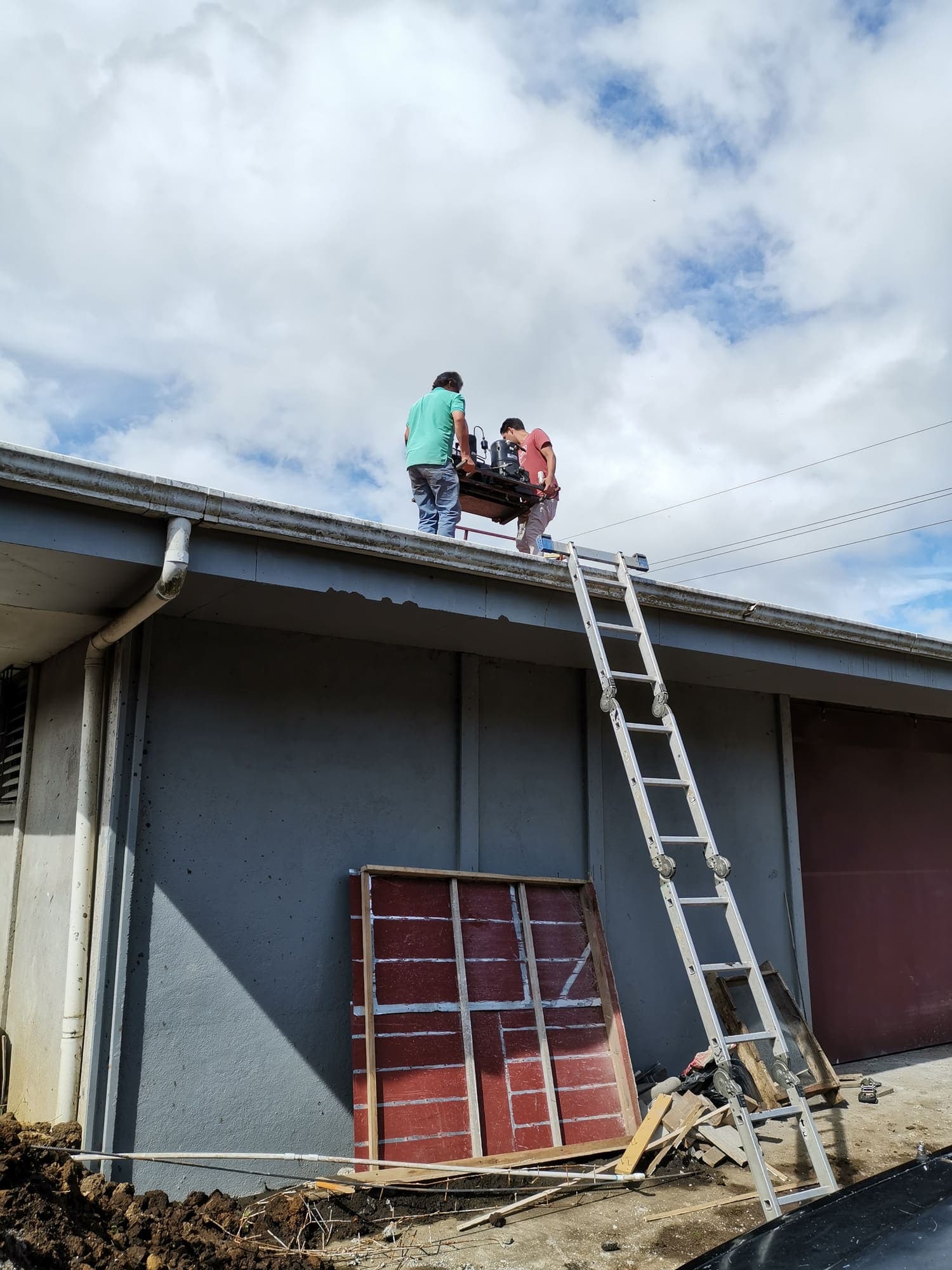 Working on the roof, the red window frames already in