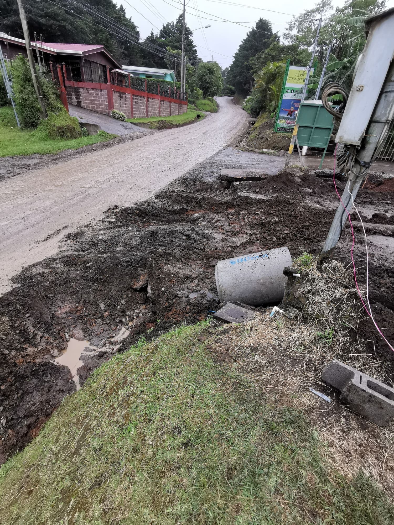 The access road with materials piled to one side