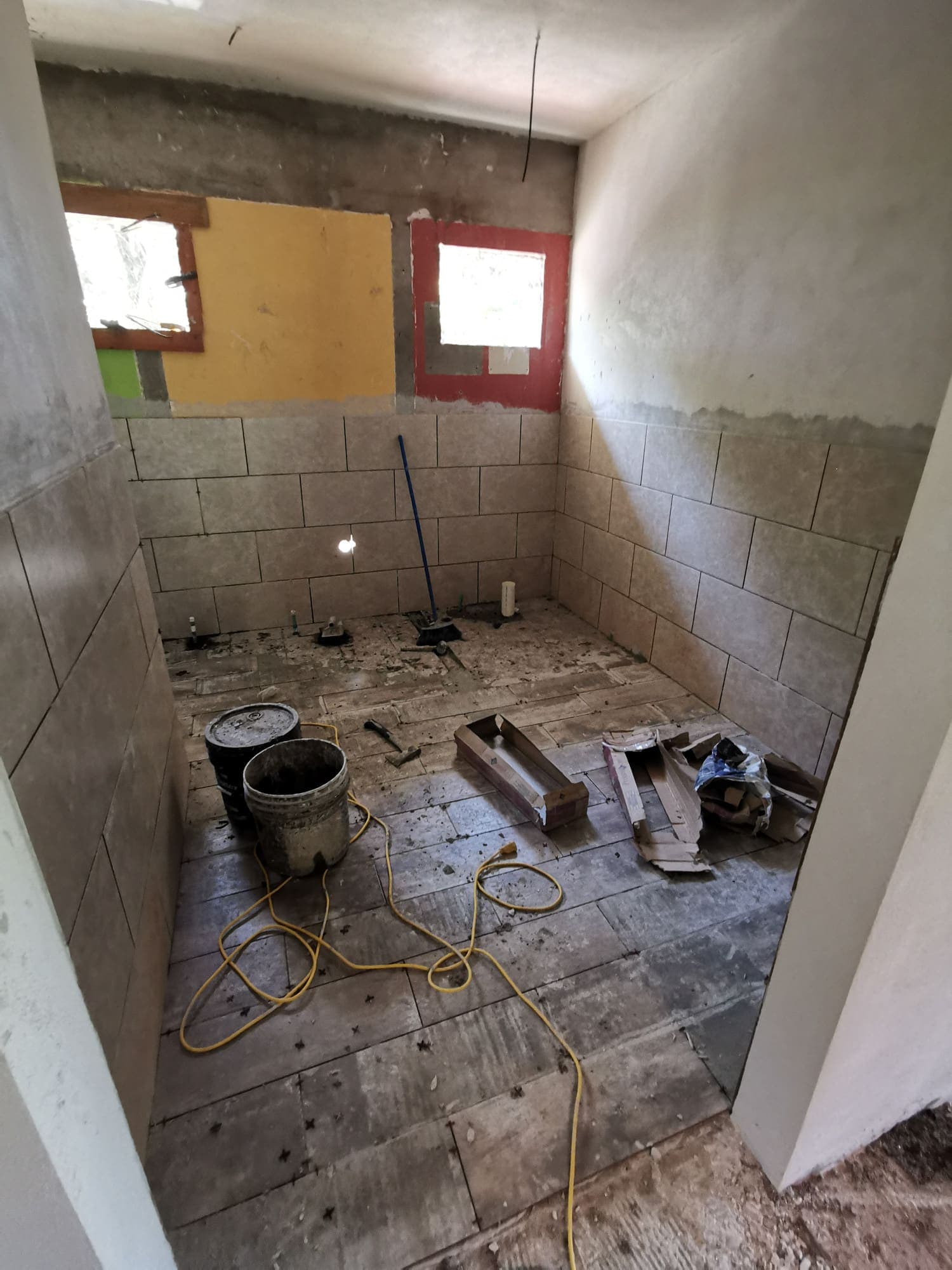 A concrete block room, tools on the floor