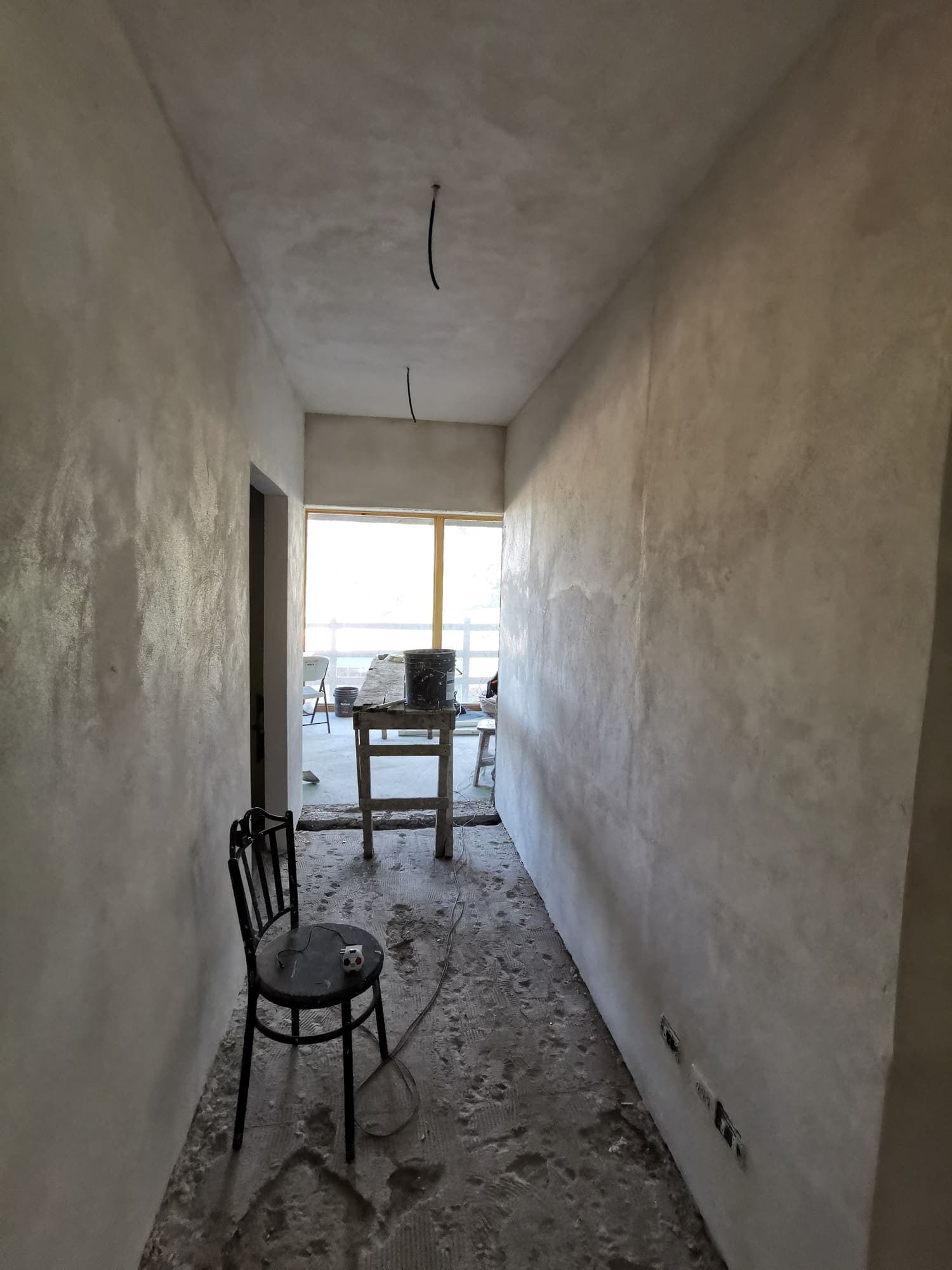 The long room still empty, a single chair at the end