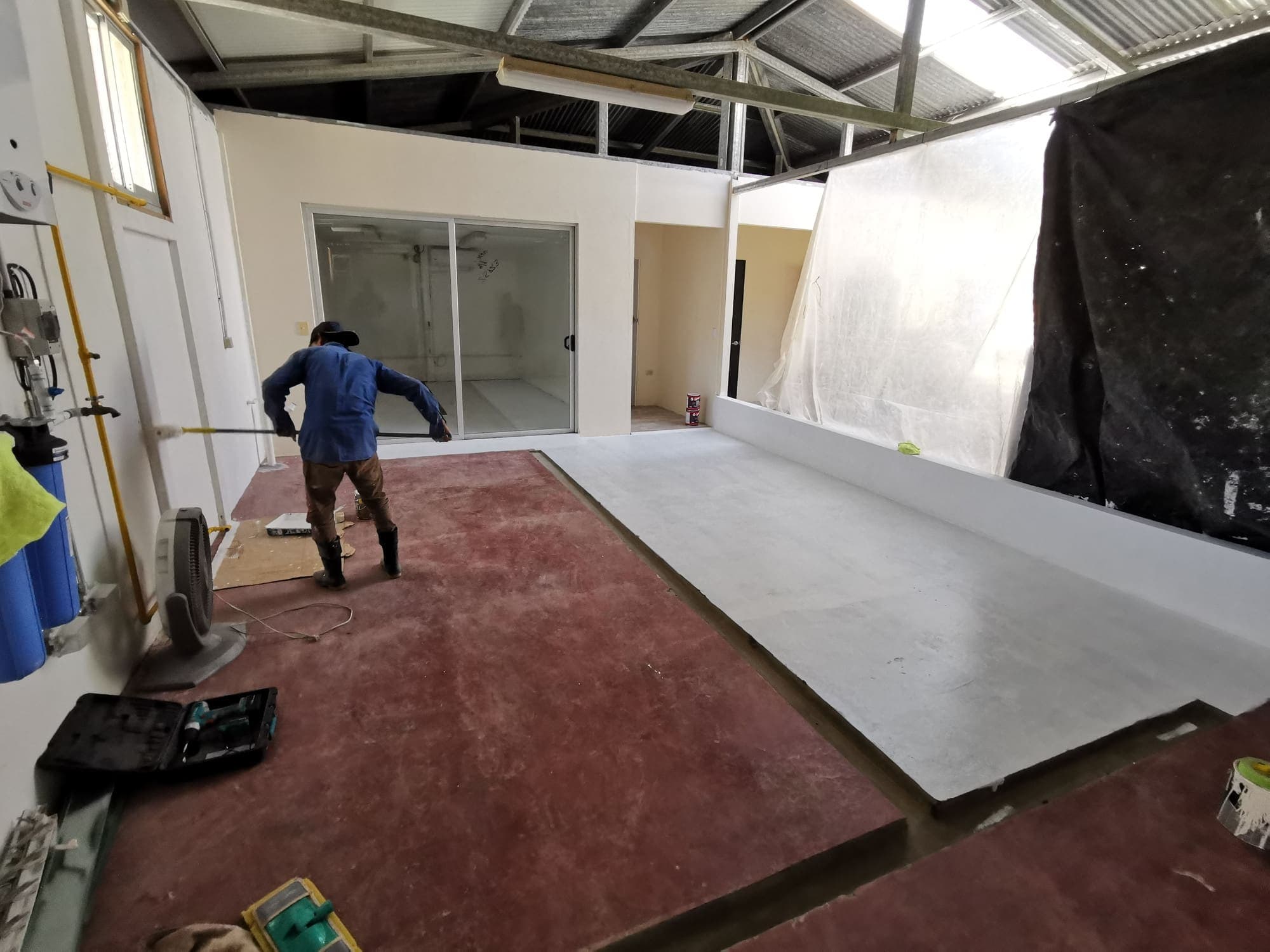 Rolling out the new flooring across the room