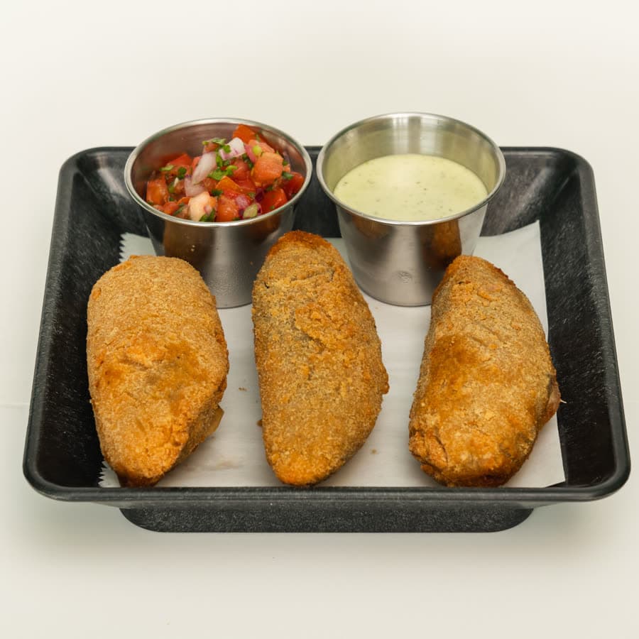 Breaded jalapeño poppers with pico de gallo and white sauce