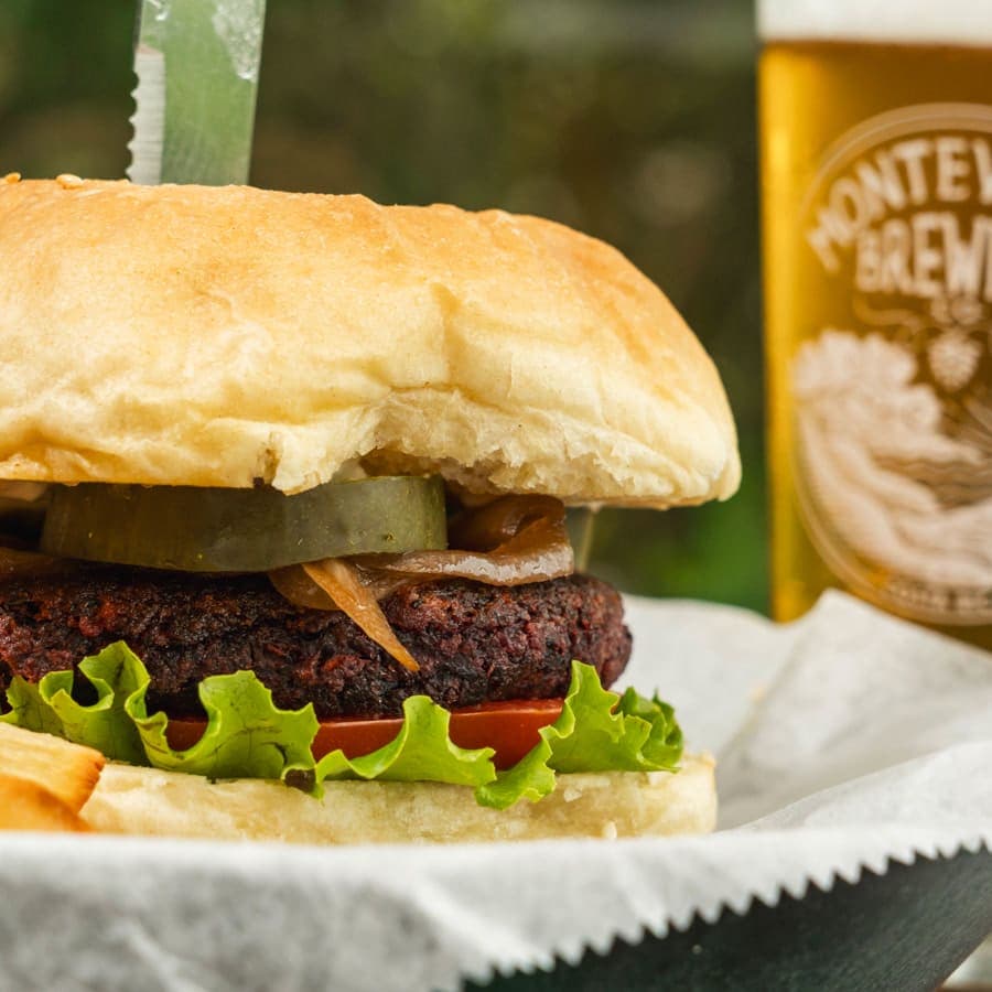 Beet and bean patty burger with pickle, lettuce and tomato