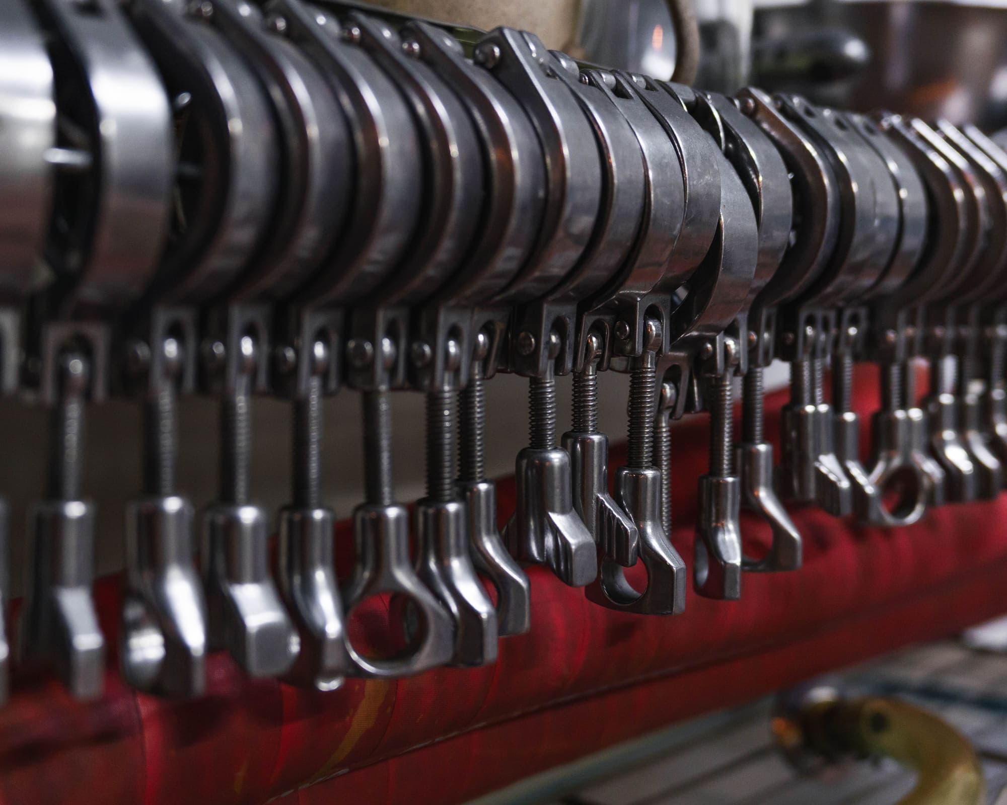 A row of hanging keg couplers
