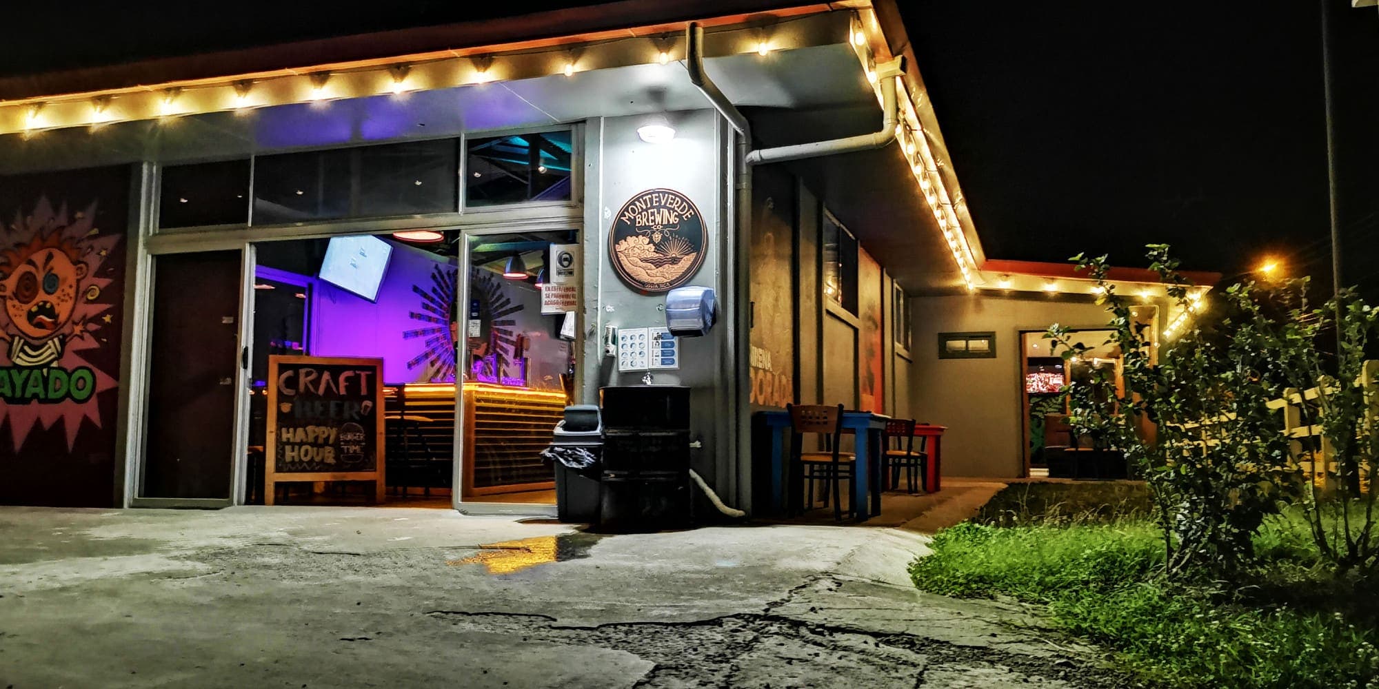The Monteverde Brewing Company brewpub at night, string lights above the entrance