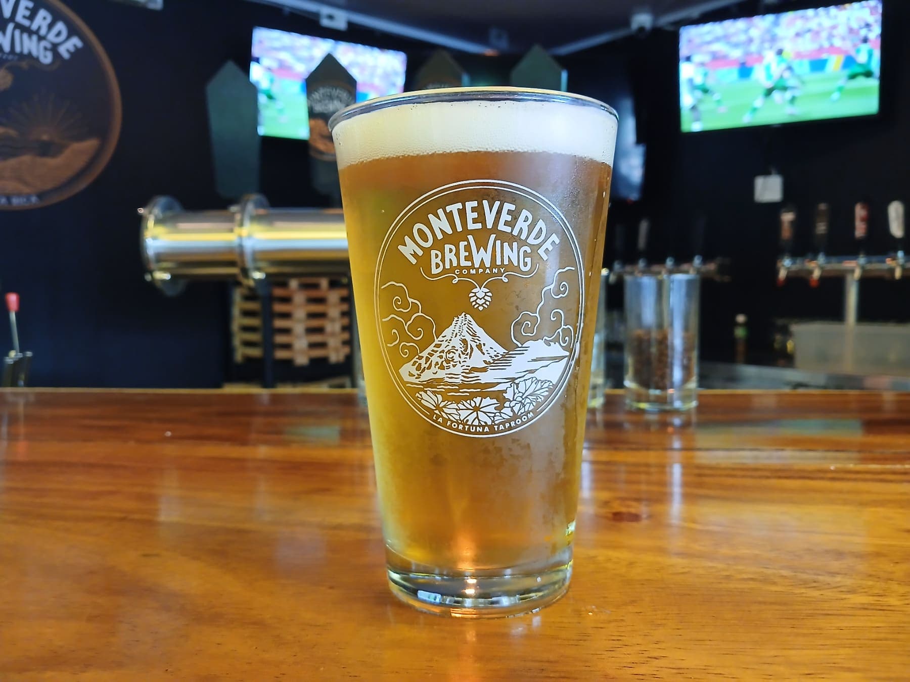 A pint of golden beer on the bar of the La Fortuna taproom